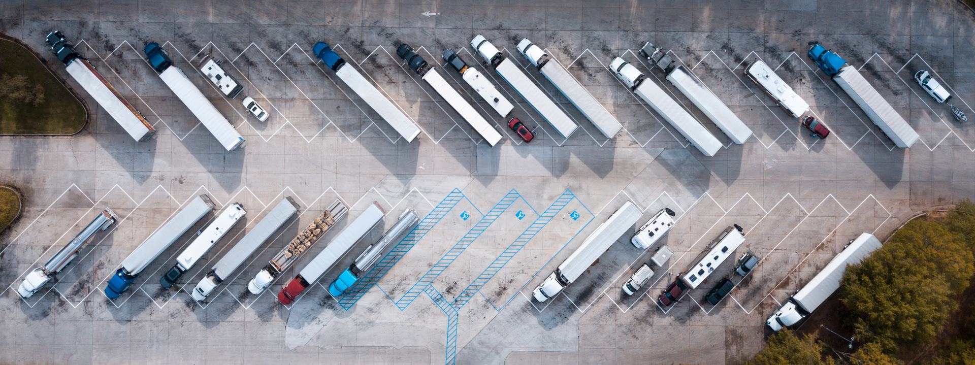 Aerial view of freight trucks parked in a logistics yard